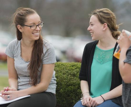 Campus Scenic - Students Talking by bushes - Spring 062